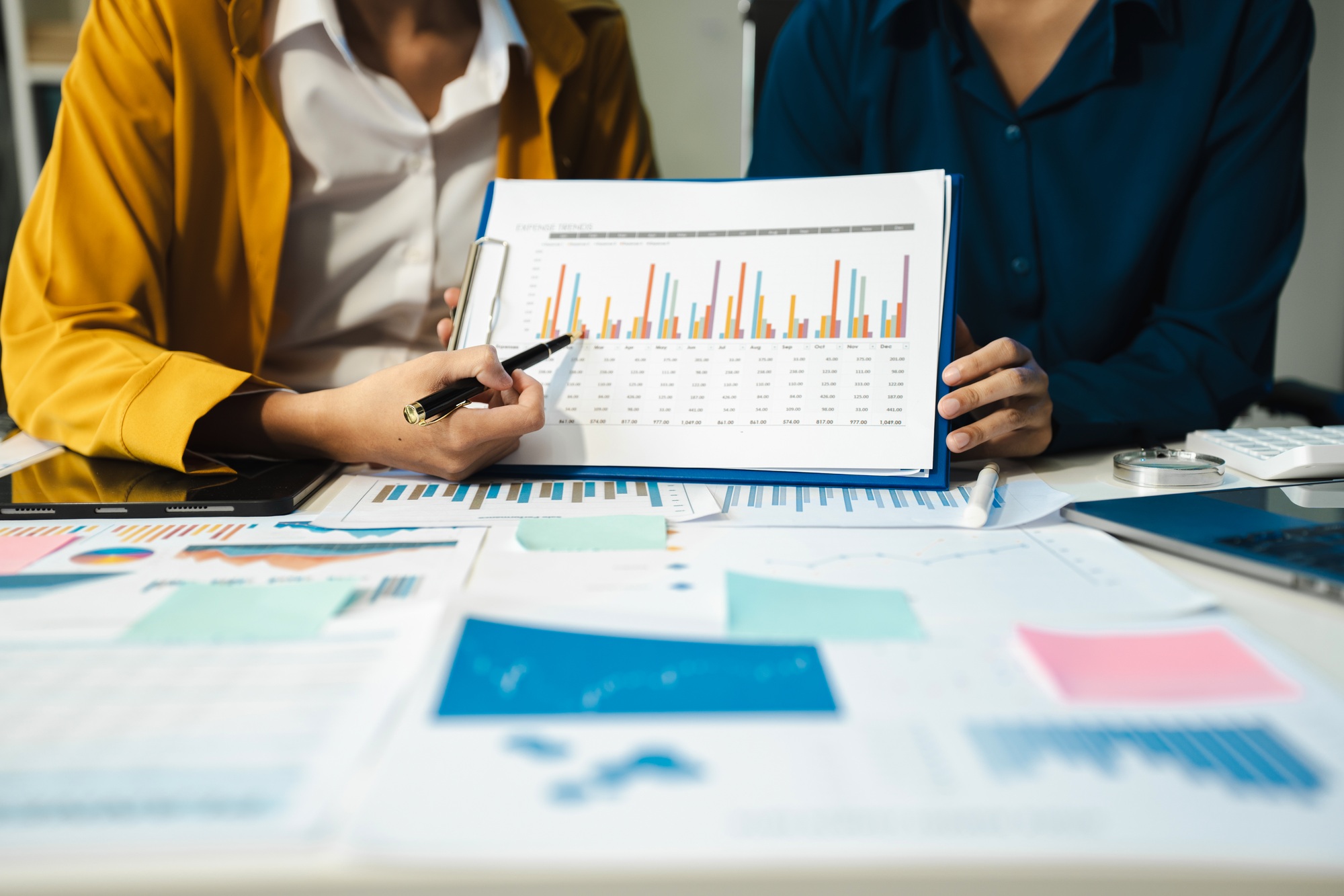 financial advisor showing plan of investment to clients in the consultancy.